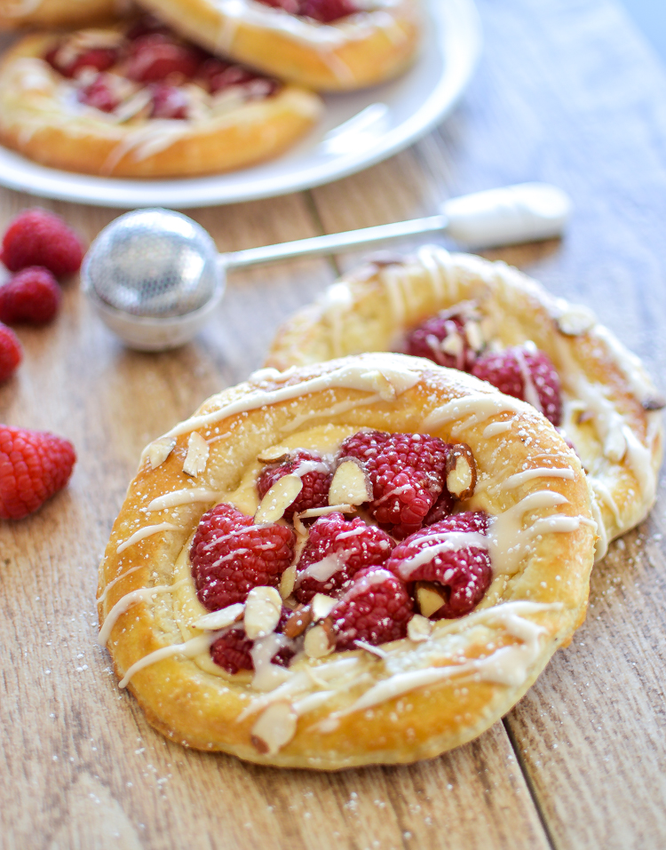 Raspberry Danish pastries with icing and almond slices