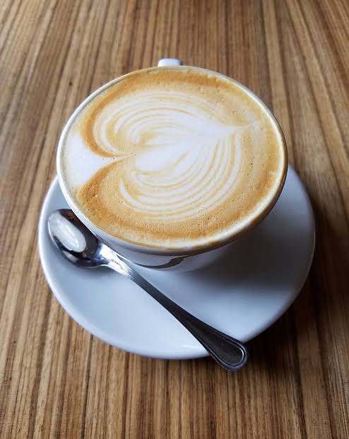 Cup of coffee with latte art on a wooden table